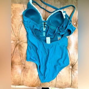 Blue green one piece with bordering white flowers.